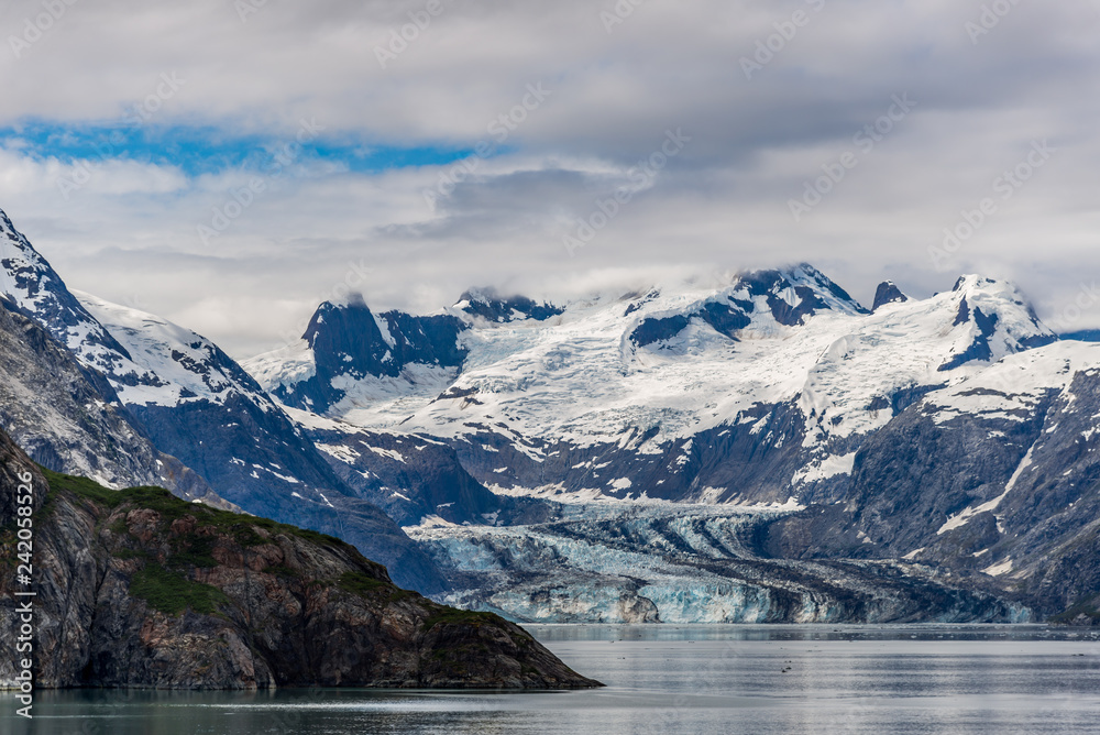 Fototapeta premium Johns Hopkins Glacier and mountains on a cloudy day in Glacier Bay, Alaska