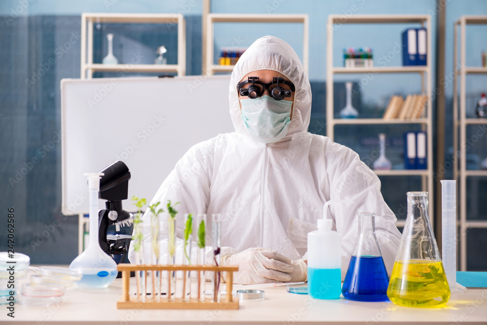 Male biotechnology scientist chemist working in the lab Male biotechnology scientist chemist working in the lab