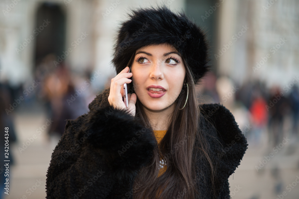 Smiling young woman talking on the cellphone Smiling young woman talking on the cellphone