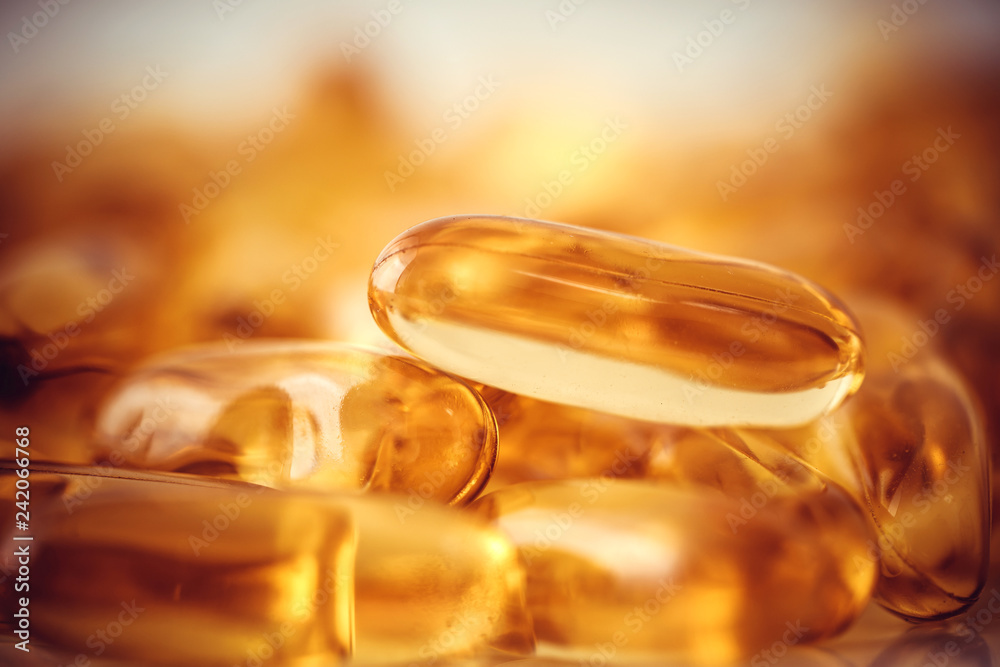 Close up the vitamin D and Omega 3 fish oil capsules supplement for good brain , heart and health eating benefit Close up the vitamin D and Omega 3 fish oil capsules supplement for good brain , heart and health eating benefit