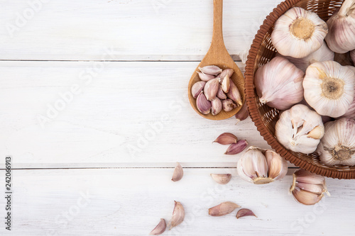 Close up group of a garlic on white wooden table board , top view or overhead shot with copy space