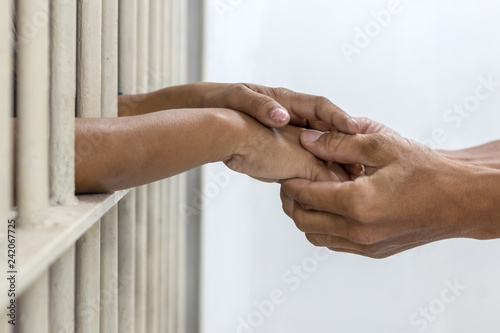 Hand handshake husband and wife who were imprisoned.