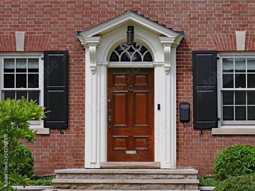 elegant dark wood door of brick house