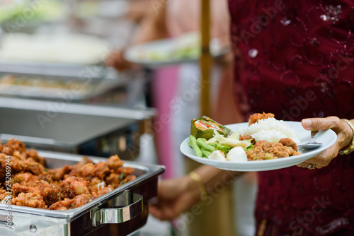 scooping the food, buffet food at restaurant, catering 