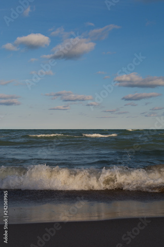 Lake Michigan on a beautiful Autumn morning with blue skies and clouds above. Indiana Dunes, Indiana, USA