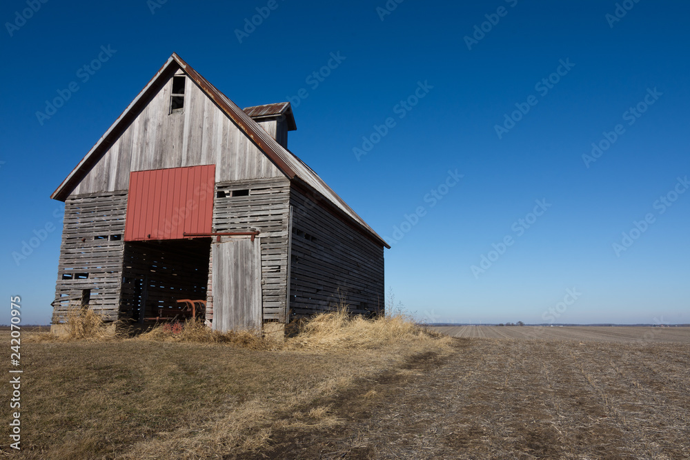 Old wooden barn in the rural open farmland. Illinois, USA Old wooden barn in the rural open farmland. Illinois, USA