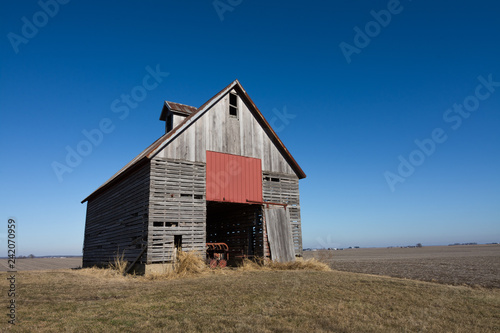 Old wooden barn in the rural open farmland. Illinois, USA