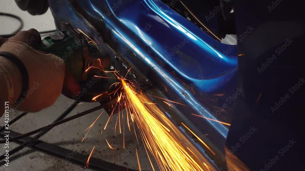 Metal worker grinding in auto body repair shop, closeup, 4k Metal worker grinding in auto body repair shop, closeup, 4k
