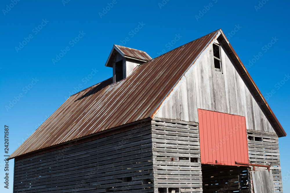 Old wooden barn in the rural open farmland.  Illinois, USA