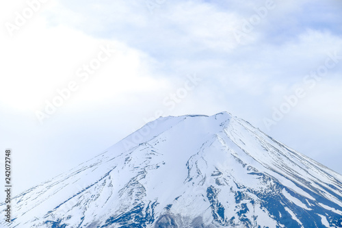 Fuji Mountain on top  white isolated clouds sky background  blue mountain snow on top  close up focus Fuji mountain in Japan.