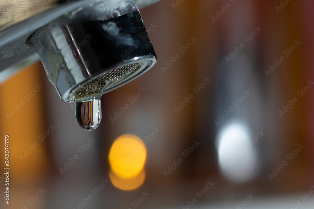 Leaking Faucet from a side profile room for copy space Leaking Faucet from a side profile room for copy space