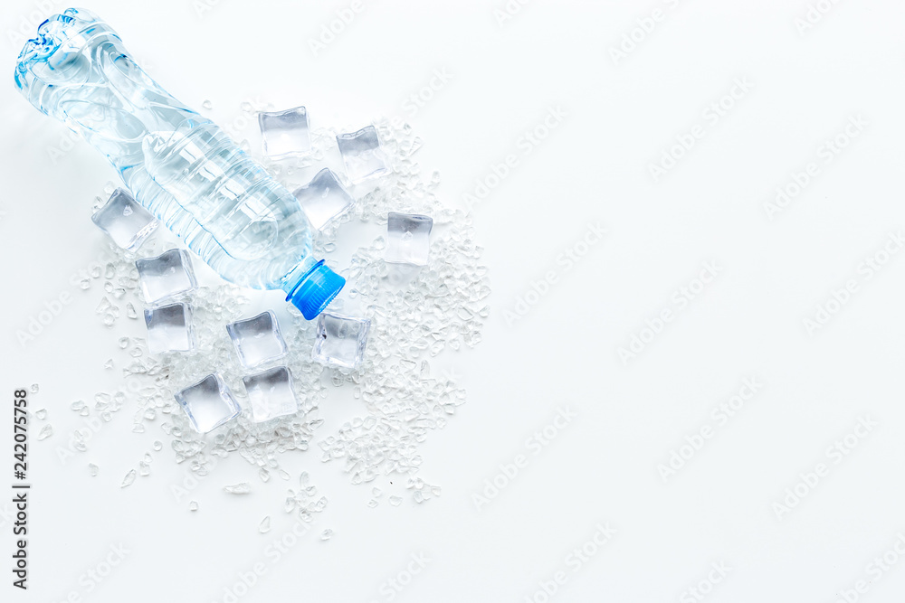 Bar desk with ice cubes and plastic bottle on white background top view space for text Bar desk with ice cubes and plastic bottle on white background top view space for text