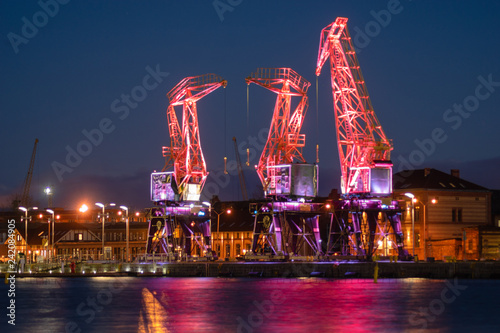 Szczecin,Poland-December 2018:Illuminated old port cranes on a boulevard in Szczecin City at night