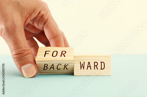 person hand flipping wooden cubes so that it will be written forward instead of backward. personal development and positive thinking concept.