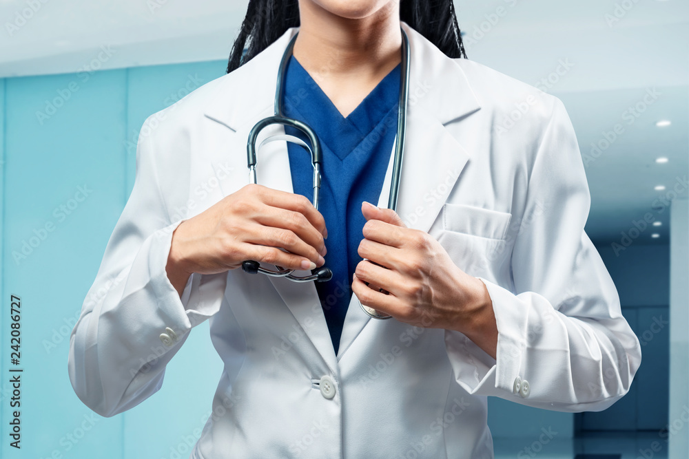Female doctor with white coat and stethoscope Female doctor with white coat and stethoscope