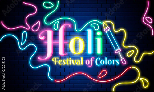 Neon text Holi, Festival Of Colors with color gun on blue brick wall background.