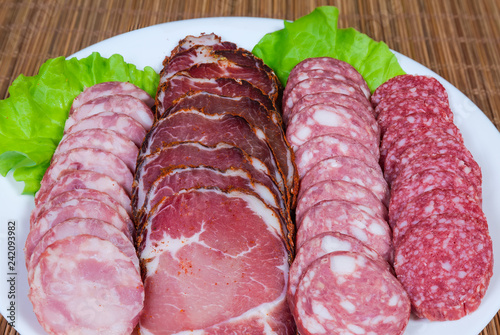 Cold cut of dried meat and different sausages close-up