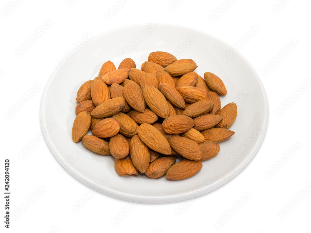 Almonds peeled from shells on a white saucer Almonds peeled from shells on a white saucer