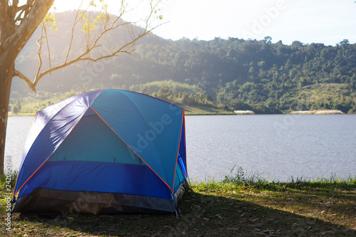 Camping tent near lake with beautiful sunlight in morning