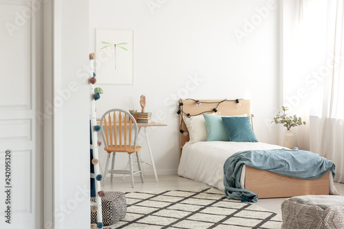 White and wood scandinavian kid's room with comfortable single bed and workspace with desk and chair photo