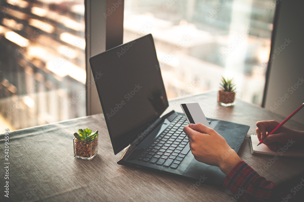 Fototapeta premium Online shopping and online payment for purchases, goods by credit card with using a laptop. Order goods online