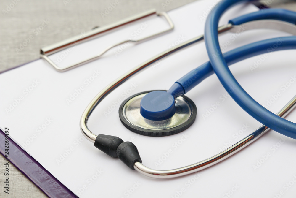 A stethoscope and a clipboard for notes as a medical check concept A stethoscope and a clipboard for notes as a medical check concept