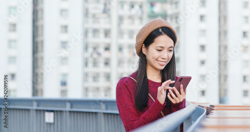 Woman check on mobile phone in city Free Download Woman check on mobile phone in city - GFXLoad