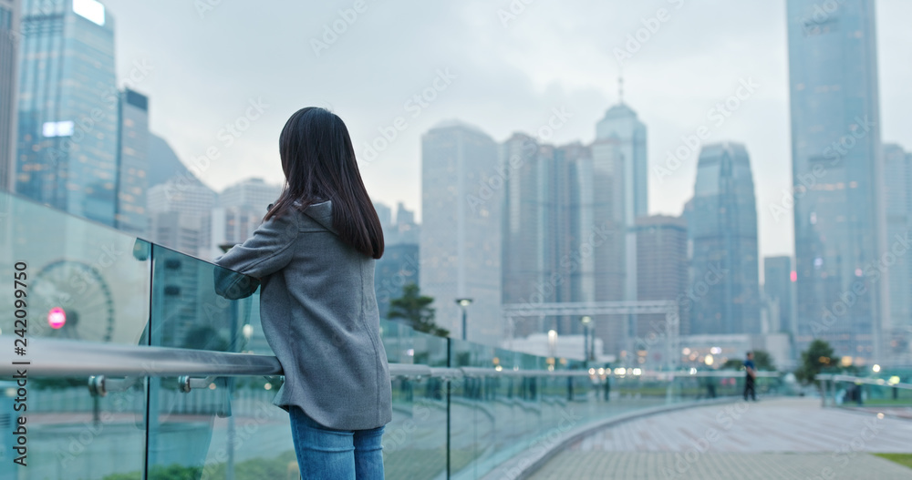 Woman look at far away in the city