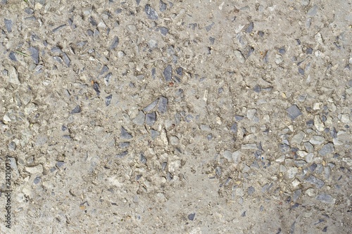 The concrete floor was eroded, saw the sand stone mixture in the background.