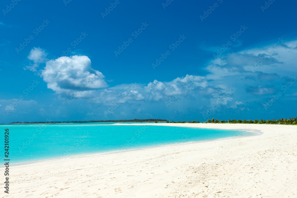 tropical Maldives island with white sandy beach and sea