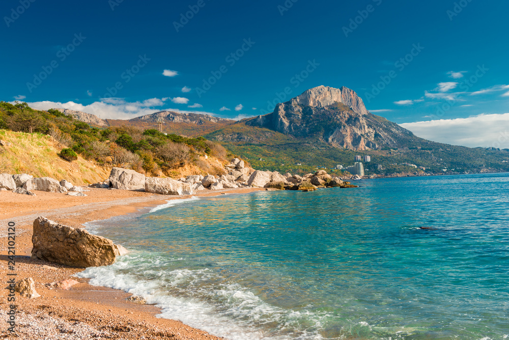 The bay of the sea with clear azure water and high mountains, sunny landscape, Crimea, Russia