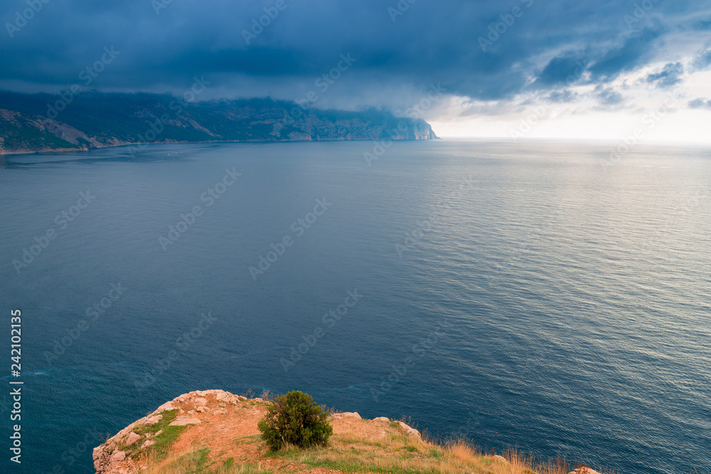 View of the sea, mountains and dramatic sky from the cliff, beautiful landscape