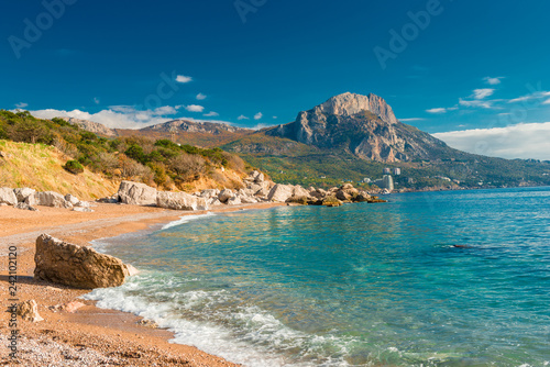 The bay of the sea with clear azure water and high mountains, sunny landscape, Crimea, Russia
