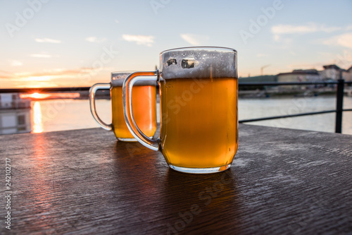 Two glass of beer on the brown wooden table, Slovakia