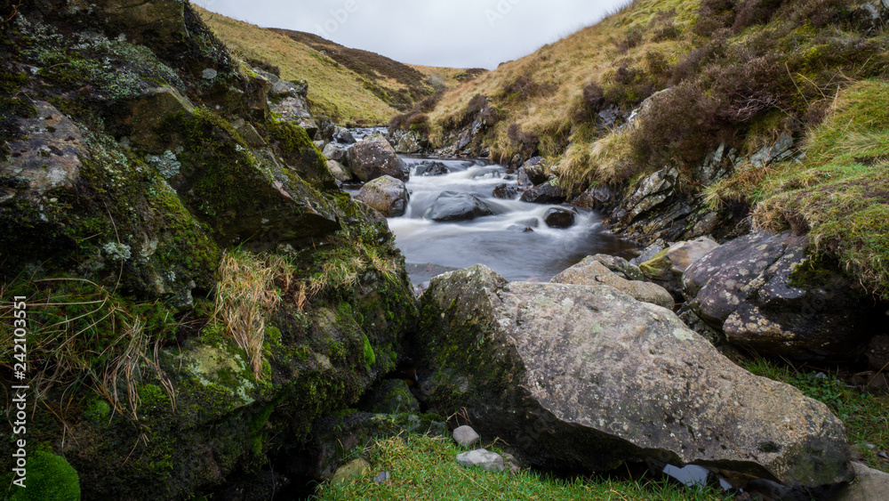Hiking in Scottish outdoors with waterfalls, rivers and lush greenery