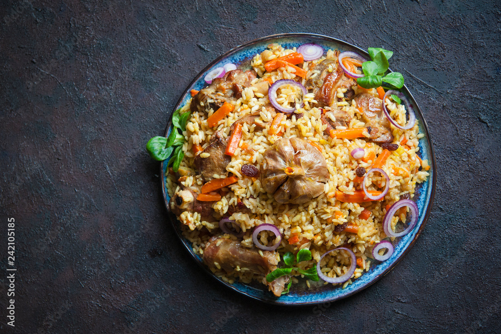 Uzbek plov a rice dish prepared with lamb, stewed with fried onions, garlic and carrots rice, dried fruits, garlic and cumin. Uzbek plov a rice dish prepared with lamb, stewed with fried onions, garlic and carrots rice, dried fruits, garlic and cumin.