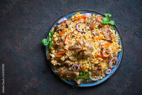 Uzbek plov  a rice dish prepared with lamb,  stewed with fried onions, garlic and carrots rice,  dried fruits,  garlic and cumin.