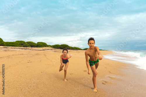 Kids playing on the beach. Active and healthy childhood.