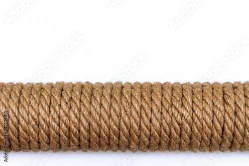 Sisal rope cat scratching post on white background. Copy space for text photo