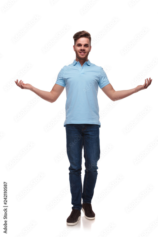 attractive man in polo shirt making a welcoming gesture attractive man in polo shirt making a welcoming gesture