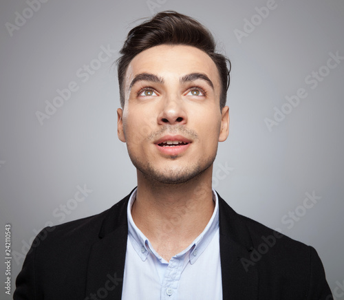 Photography portrait of curious shocked businessman looking up