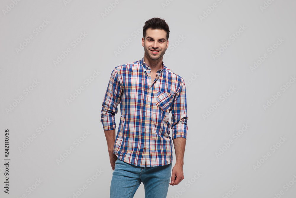 portrait of smiling casual man wearing shirt with blue checkers portrait of smiling casual man wearing shirt with blue checkers