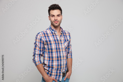 Wallpaper Mural portrait of attractive casual man standing with hands in pockets Torontodigital.ca