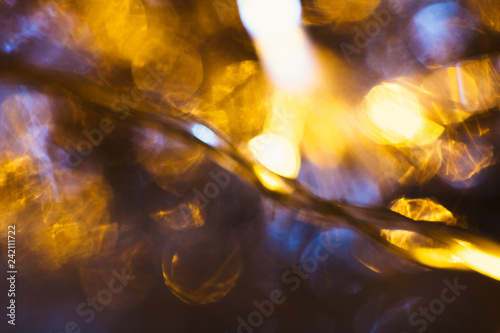 gold and silver bokeh on a dark background