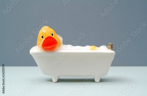 Canvastavla Giant rubber duck taking a bath, grey background