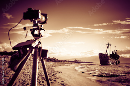 Camera on tripod and shipwreck