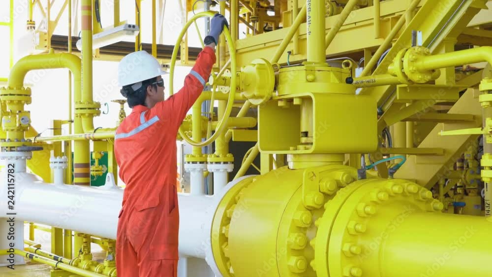 Production operator open manual ball valve of oil and gas process system to control quality of