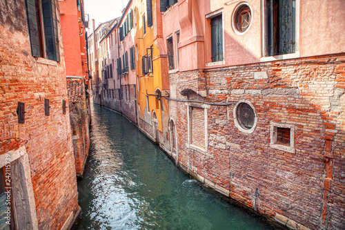 narrow canal in Venice and old architecture