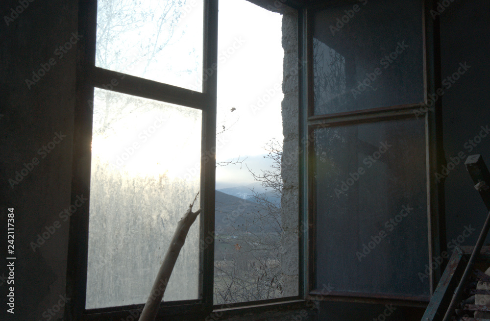 Abandoned home, window view, dark photo, view over the mountains Abandoned home, window view, dark photo, view over the mountains