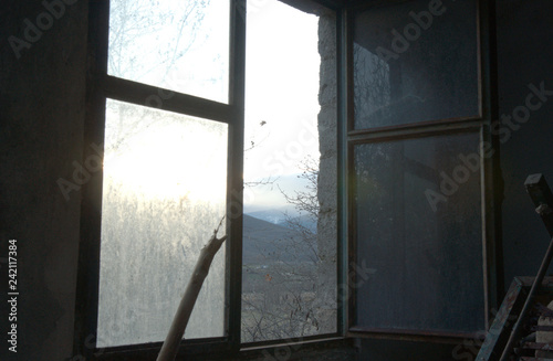 Abandoned home  window view  dark photo  view over the mountains